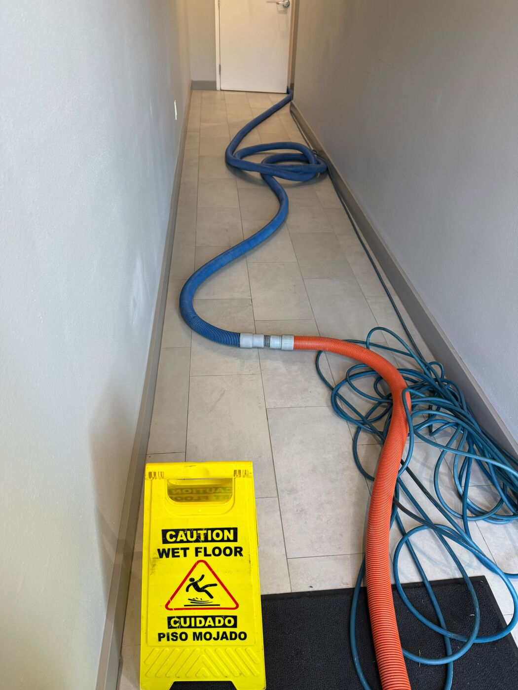 Long hallway carpet cleaning in progress